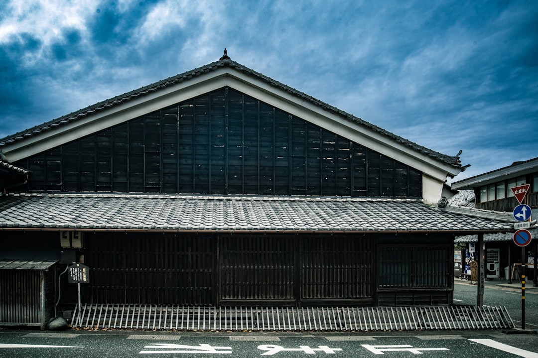 Traditional japanese building with tiled roof under cloudy sky