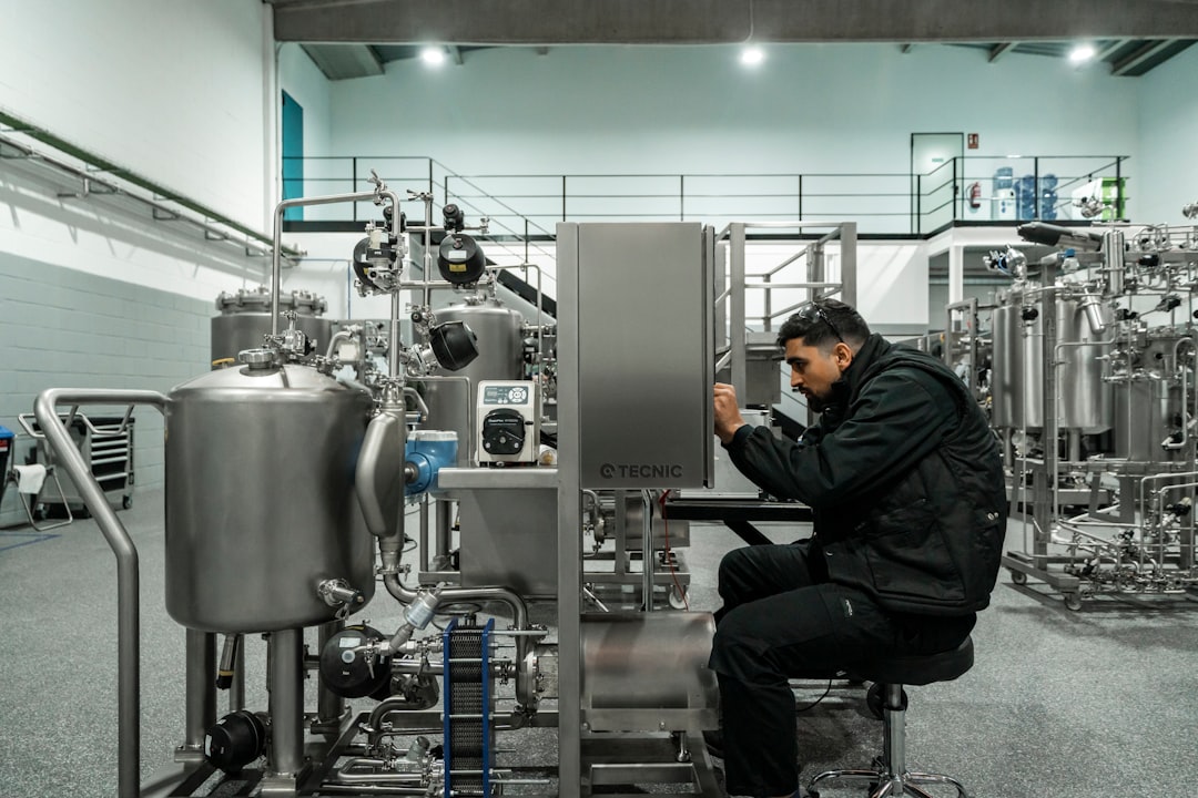 A man works on industrial machinery.