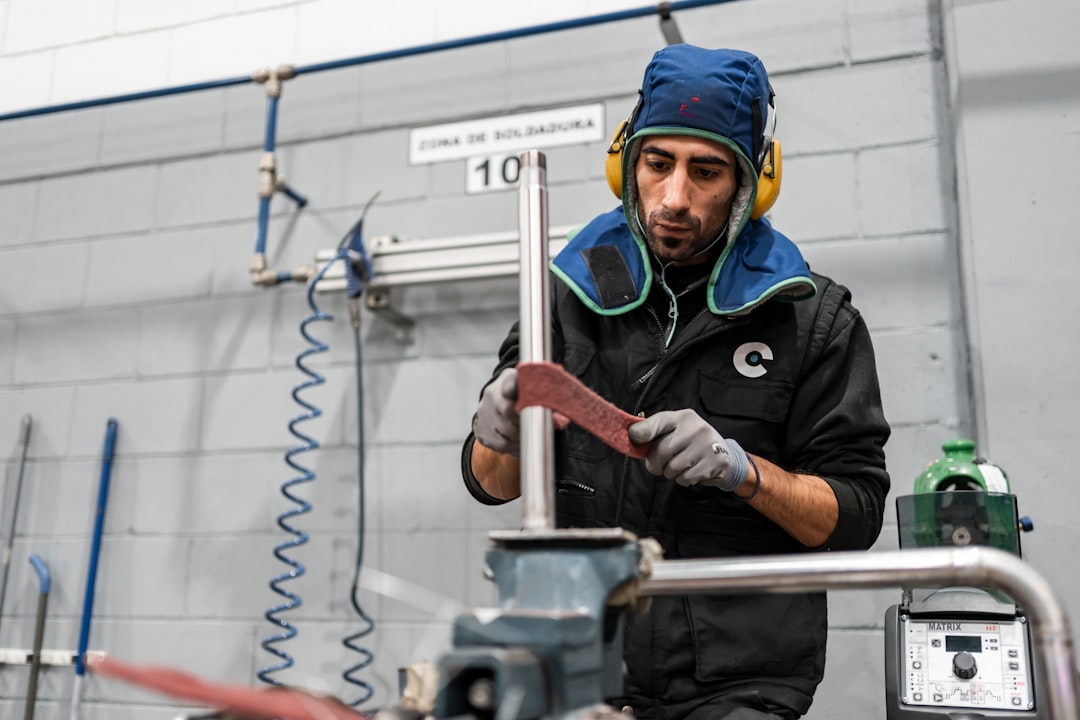 A worker is using a grinder in the workshop.